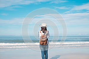 Traveler young woman in casual clothes with backpack stand alone