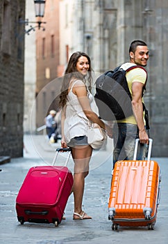 Travelers with baggage in the street