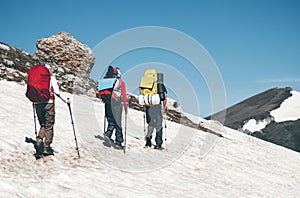 Travelers climbing in mountains with backpack