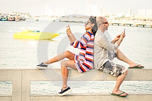 Travelers couple in disinterest moment with mobile phones