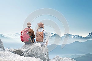 Travelers couple look at the mountains landscape. Travel and active life concept with team.