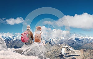 Travelers couple look at the mountains landscape. Travel and active life concept with team.