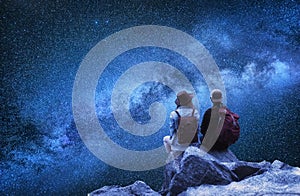 Travelers couple look at the stars. Travel and active life concept with team.