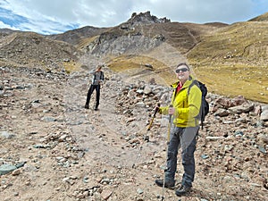 Travelers father and son in mountains