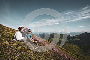 Travelers, friends relax on the mountain trail