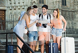 Travelers holding map and looking way