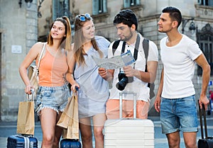 Travelers holding map and looking way