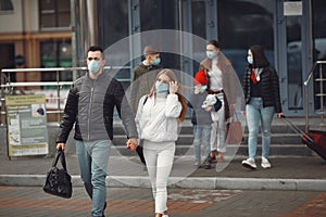 Travelers leaving airport are wearing protective masks photo
