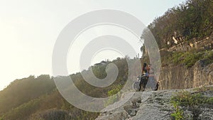 Travelers in love stopped on a motorcycle at the edge of the earth