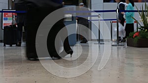 Travelers passengers in airport transit terminal walking with luggage baggage going traveling.