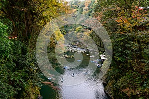 Travelers on a rowing boat at Takachiho Gorge in Kyushu