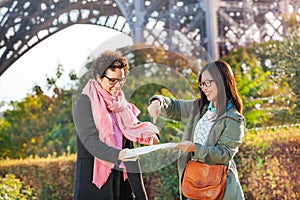 Travelers searching right direction on a paper map