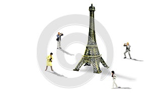 Travelers taking photograph Eiffel Tower model isolated on white background.