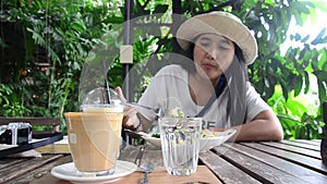 Travelers thai woman eating breakfast salad and coffee after writing note
