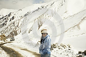 Travelers thai woman travel visit take photo at Khardung La Road on top of himalaya mountain at Leh Ladakh winter season in India