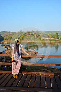 Travelers thai women people travel visit and portrait posing for take photo on Saphan Mon or Uttamanusorn longest wooden bridge