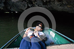 Travelers thai women people travel visit shooting take photo on boat tour trip Tam Coc Bich Dong or Halong Bay on Land and Ngo