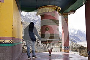 Travelers thai women visit travel and praying and rite rotate and spin Prayer wheels in Diskit Monastery or Deskit Gompa in Nubra