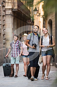Travelers with travel bags walking