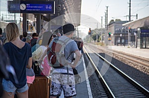 Travelers waiting for train in overcrowded station