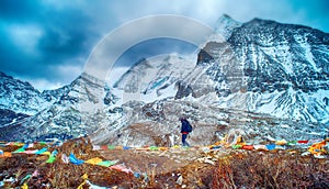 Travelers walking with snow capped mountain background to Milk Lake and Five colors lake in Yading Nature Reserve