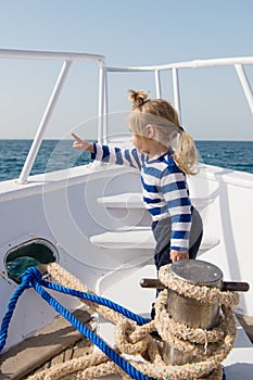 Traveling adventures and wanderlust. funny kid in striped marine shirt. happy little boy on yacht. boat trip by sea