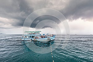 Traveling boat with passenger go to island while raining strom near comes