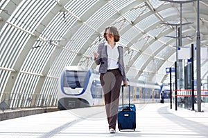 Traveling business woman walking with bag and phone