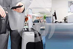 Traveling businessman calling by phone at the airport