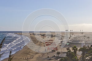 Traveling on Canary islands. Sunny View of Playa del Ingles Beach in Maspalomas Located in Gran Canaria with Sand Dunes and Windy