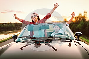 Traveling by car - happy couple in love go by cabriolet car in s photo