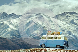 traveling car parking on road side against beautiful snow mountain background