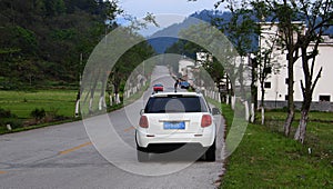 The traveling car travels in the fields in spring