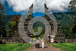 Traveling couple in Bali. Happy couple vacationing in Asian countries. Couple at the Bali gate.