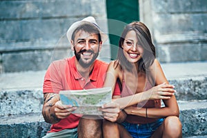 Traveling couple of tourists walking around old town.