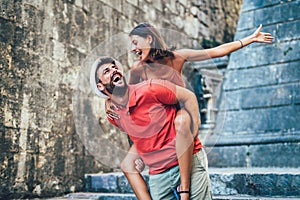 Traveling couple of tourists walking around old town.