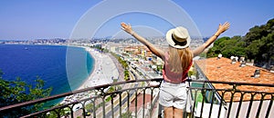 Traveling in France. Panoramic view of beautiful girl with open arms on Nice city, French Riviera