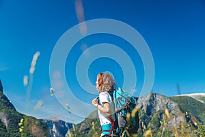 Traveling girl hiking with backpack in mountains adventure journey lifestyle vacations weekend  Norway