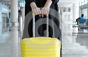 Traveling girl with a suitcase at the airport. Vacation, planes, flights, travel concept.