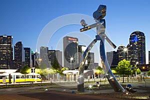 The traveling man and skyline of Dallas at night