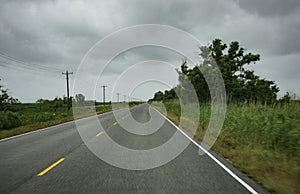 Traveling through the marsh in a car with motion blur giving the impression of speed and moving toward a destination far away