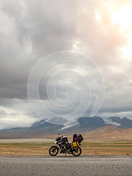 Traveling motorcycle with luggage in stormy weather