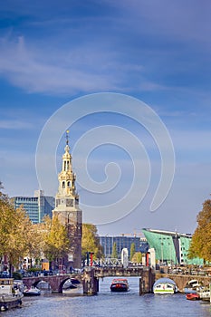 Traveling in The Netherlands. Amsterdam Cityscape With Arched Bridge For Canal Boat Cruises And Traditional Dutch Houses