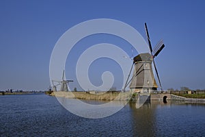 Traveling In The Netherlands. View of Traditional Romantic Dutch Windmills in Kinderdijk Village in the Netherlands