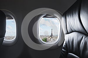 Traveling Paris, France famous landmark and travel destination in Europe. Aerial view Eiffel Tower through airplane window