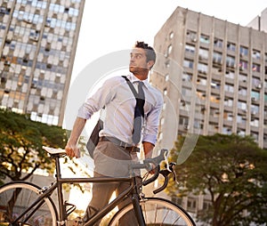 Traveling per bike today. a businessman commuting to work with his bicycle.