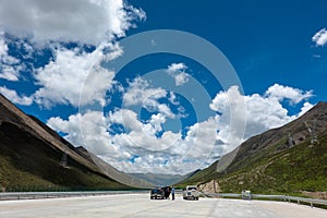 Visitors on 318 highway in Tibet under Blue sky white cloud