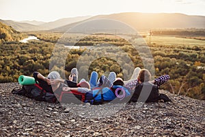 Traveling, tourism and friendship concept. Group of young friends traveling together in mountains. Happy hipster