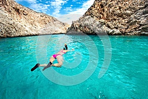Traveling and watersports details - wide angle view of woman swimming and snorkeling