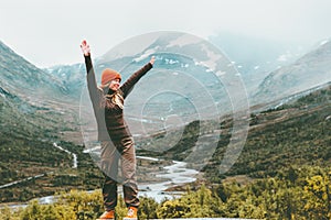 Traveling Woman happy enjoying foggy mountains